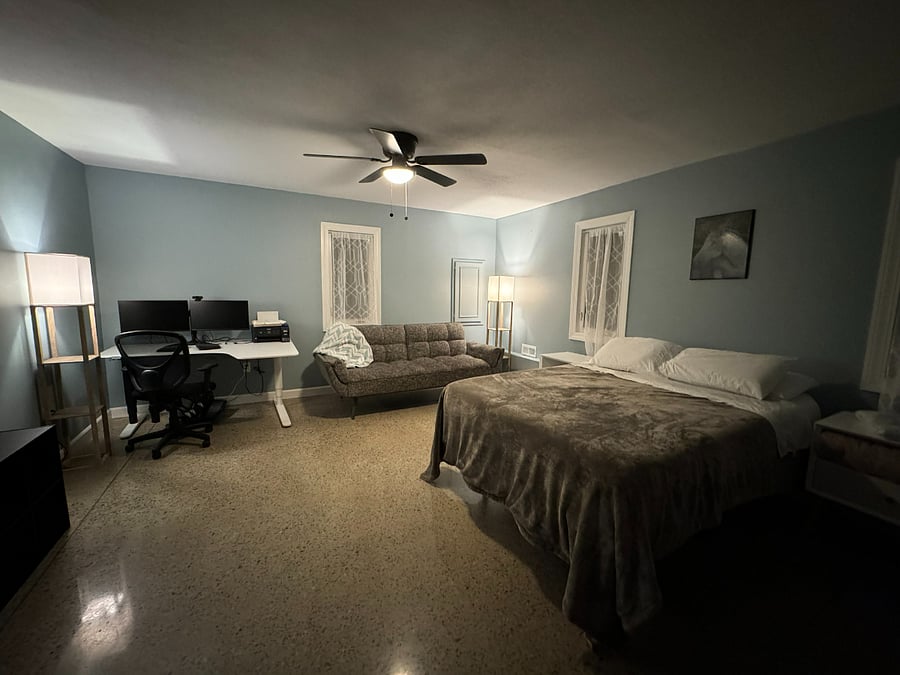 Lower level extra large front bedroom with standup desk, monitors, docking station, ergonomic keyboard, Cubbi desk elliptical