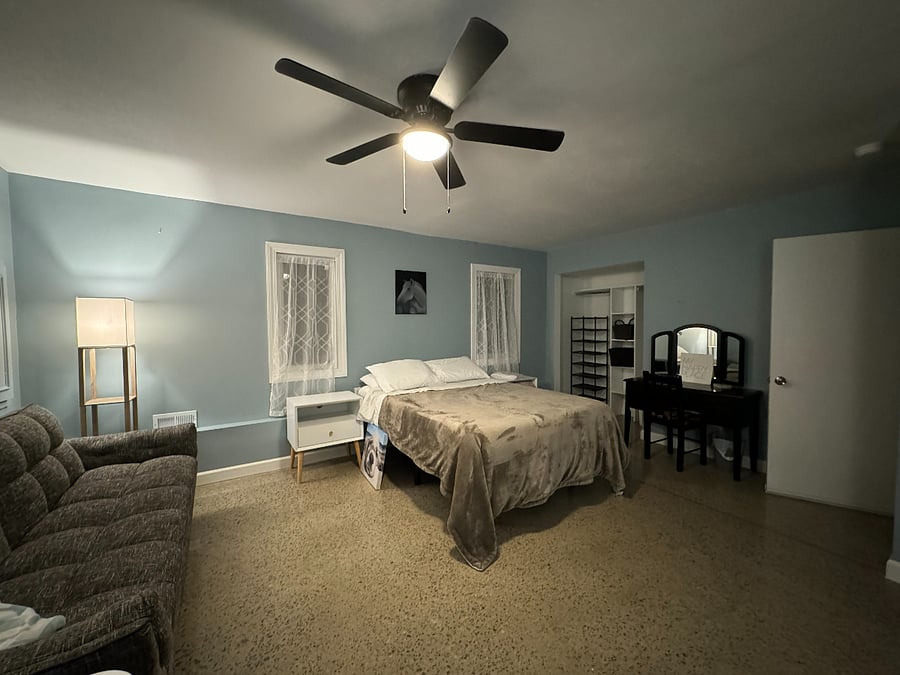 Lower level extra large front bedroom with standup desk, monitors, docking station, ergonomic keyboard