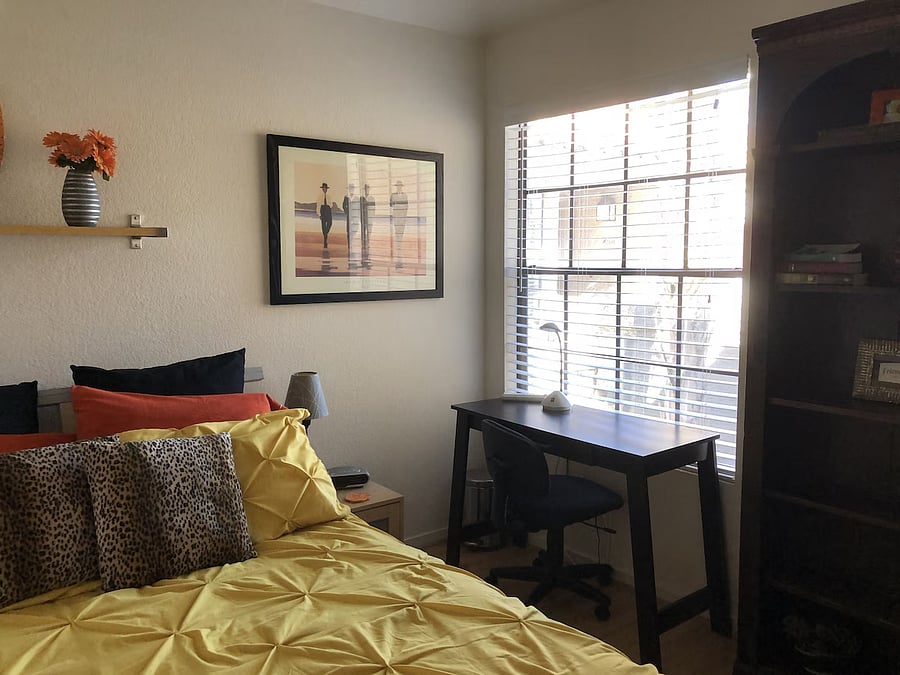Guest Bedroom with Queen bed, desk and bookshelf
