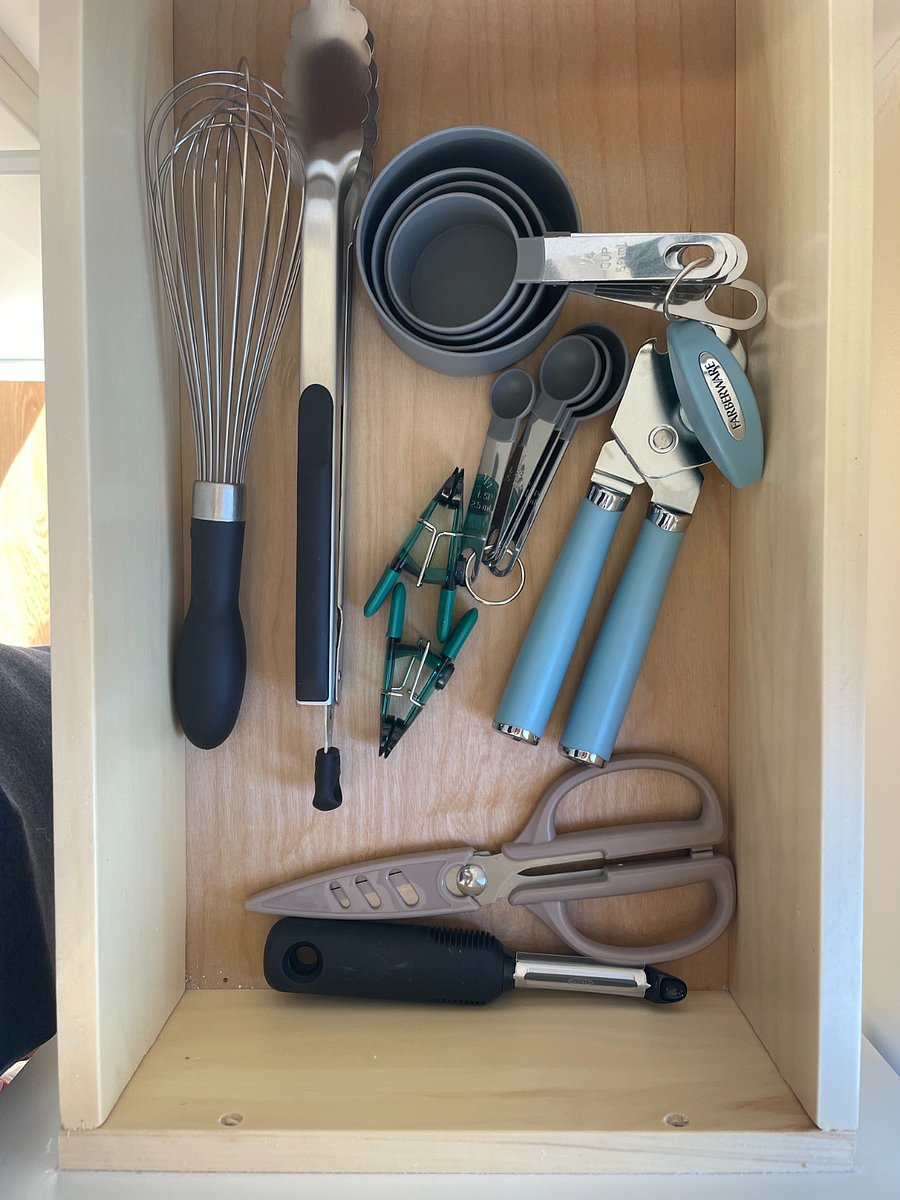 kitchen utensils, can opener, wine opener, whisk, measuring cups, scissors, tongs, etc.