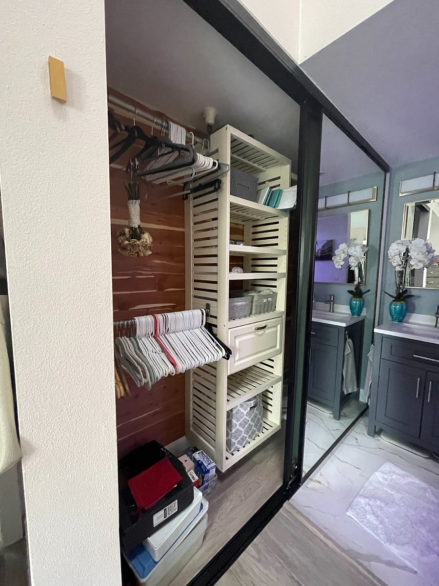 LARGE sliding mirror doors and ample closet space with one side having two racks and the other one tall rack, plus shelving and a drawer in the middle. It will be further cleaned out of personal items