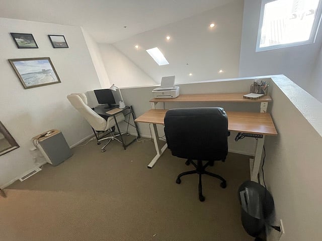 upstairs office/loft space with two desks