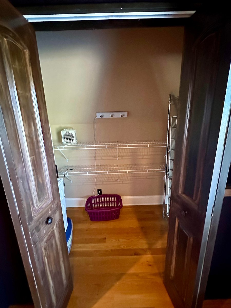 Closet complete with wire shelving, armoire hanging, and drawers