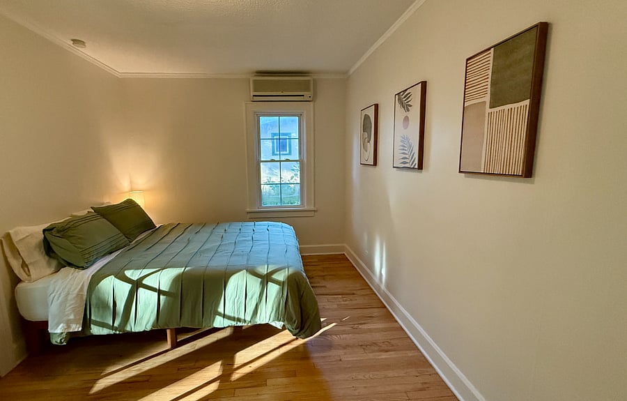 First Bedroom with Queen Bed, Dresser, Charging Bedside Lamp, and Closet.