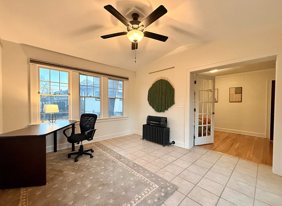 Office space with dedicated work space: Desk, Lamp, 90% Darkening Curtains, and Private entrance to backyard. 