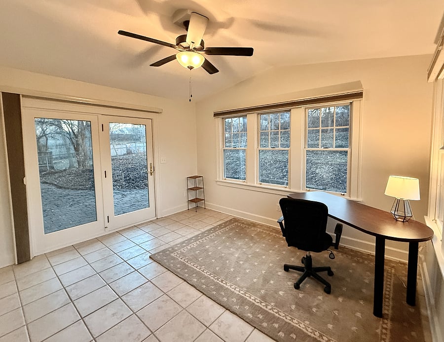 Office space with dedicated work space: Desk, Lamp, 90% Darkening Curtains, and Private entrance to backyard. 
