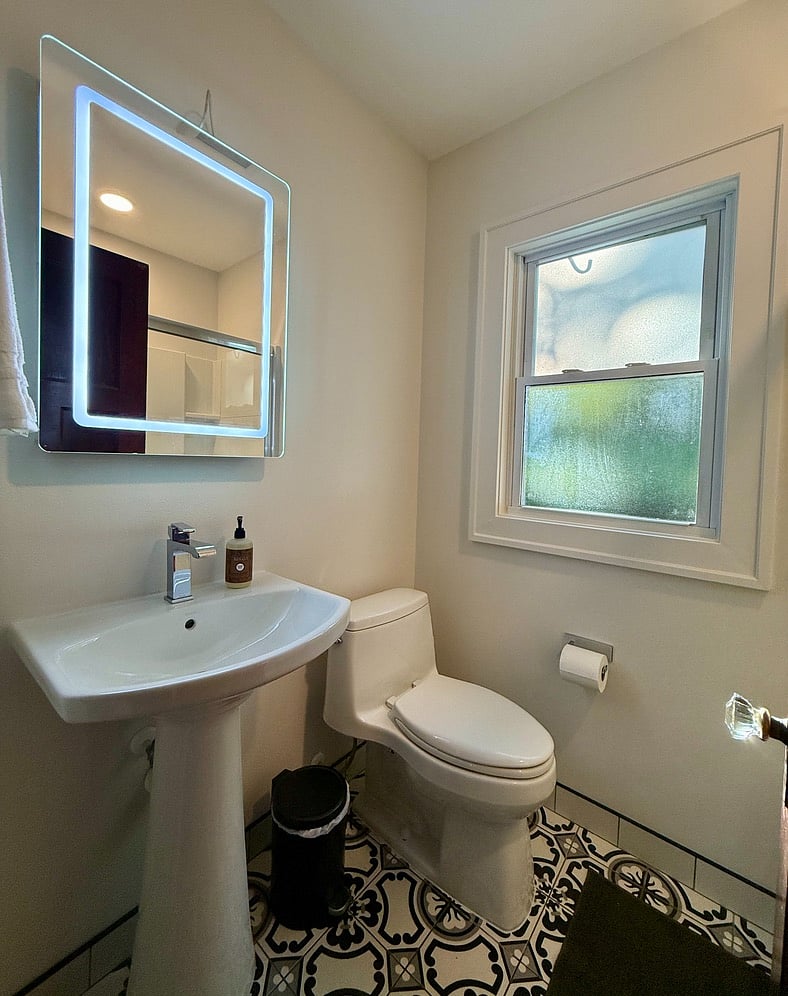 First Full Bathroom at the end of the hallway between the In-Unit Laundry and First Bedroom.