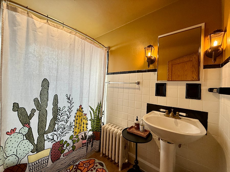 Full Bathroom with unique lighting and deep medicine cabinet.