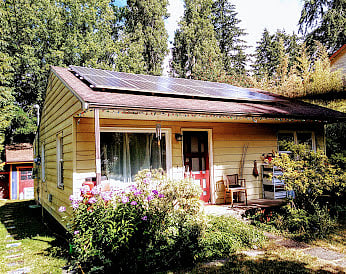 Homeowner's house at the front of the property, with side path down to the studio