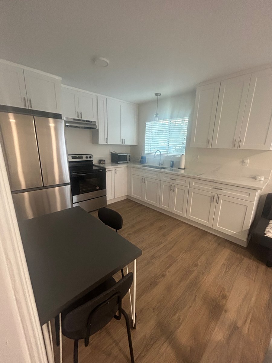 Brand new fridge with ice maker, electric stove and oven, coffee maker, and cooking supplies/utencils