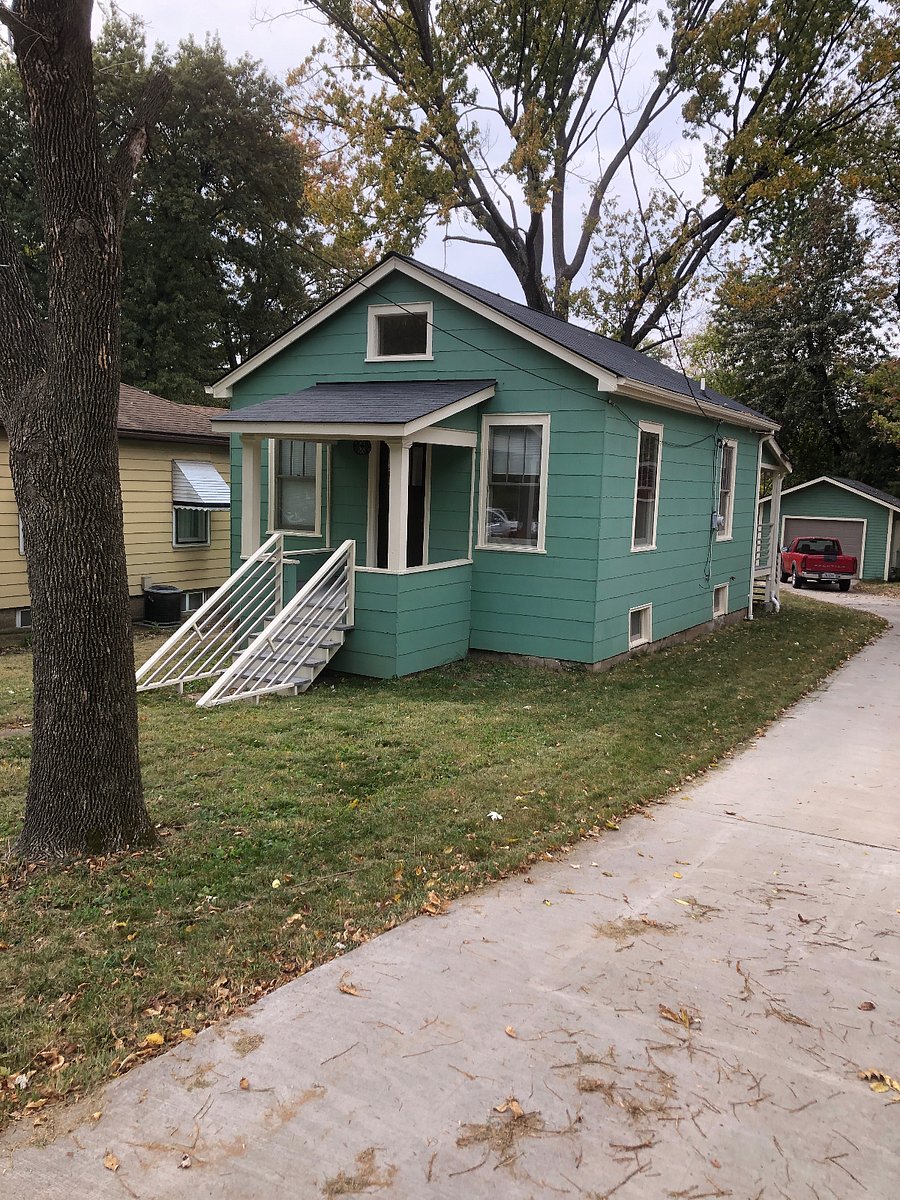 Parking area and driveway behind house. 