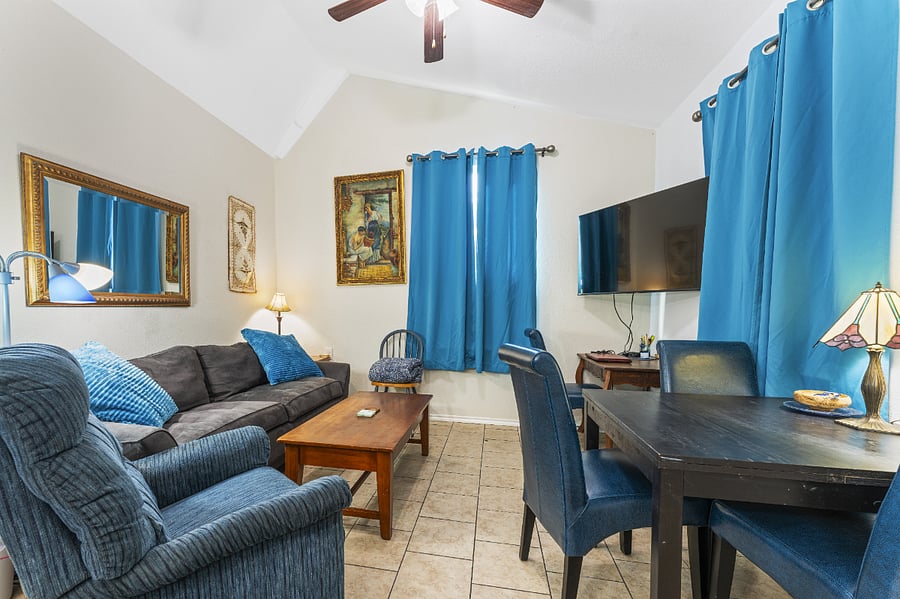 Living/dining with lots of comfy seating. Table expands. Smart TV with desk underneath.