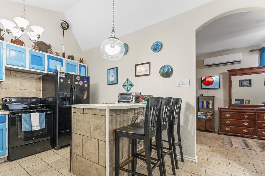 Kitchen from another angle (microwave hidden from view, inside bar island). Note the Le Creuset pot. Foodies will love the very-well-equipped kitchen.