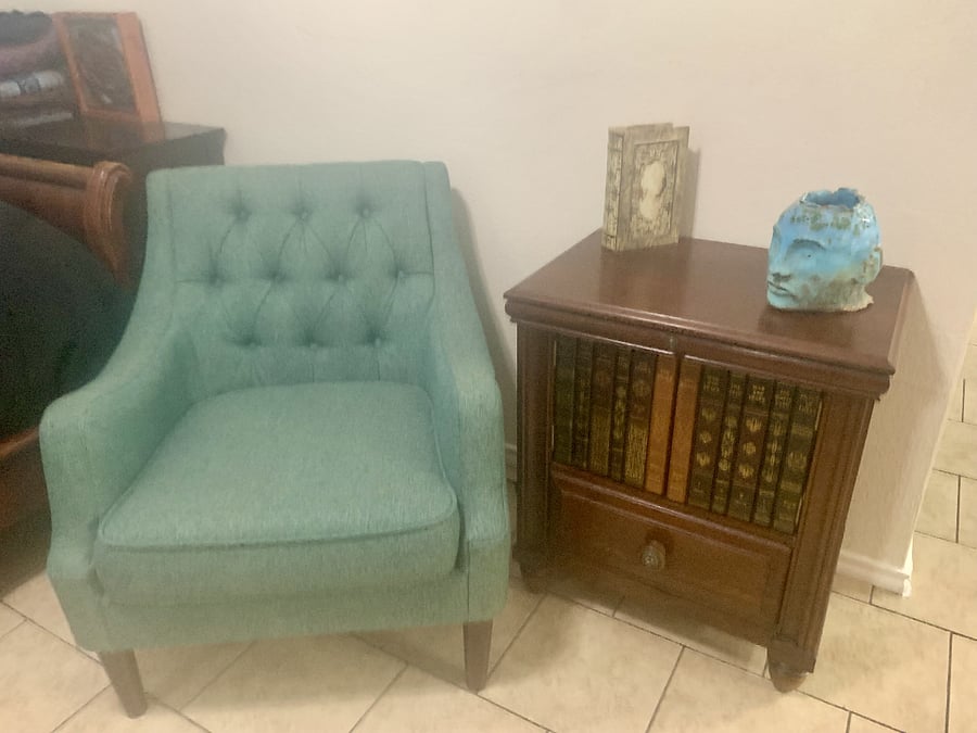 Comfy bedroom chair/reading nook with side table that has copper pull-out table for coffee/drinks