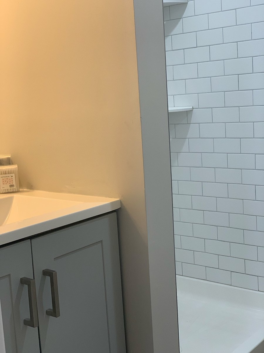 Full bathroom featuring modern, functional amenities designed for both style and convenience."