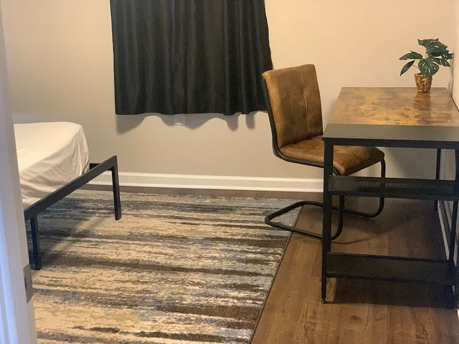 One-bedroom featuring a queen-sized bed and a dedicated desk area