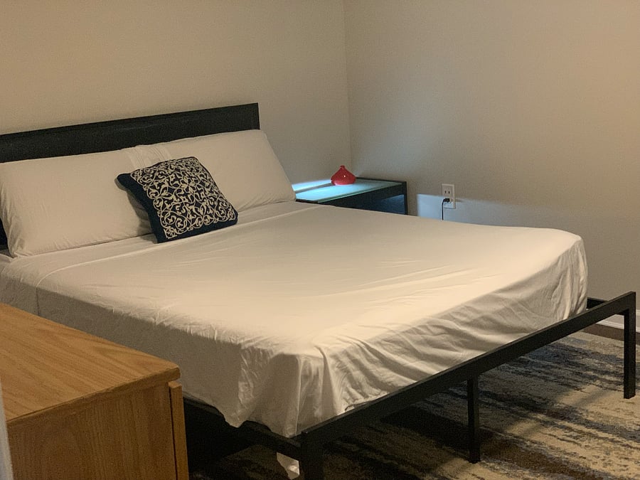 One-bedroom featuring a queen-sized bed and a dedicated desk area