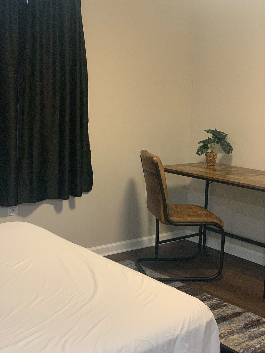 One-bedroom featuring a queen-sized bed and a dedicated desk area