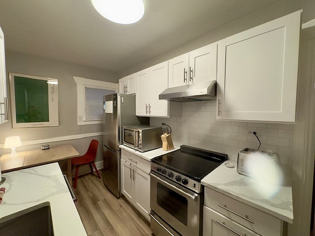 Renovated kitchen featuring modern Stainless Steel appliances, quartz countertops, and everything you'll need to feel at home and cook meals.