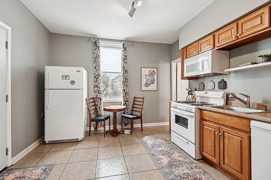 The kitchen features a quaint yet cozy dining nook! Un-pictured, but also located in the kitchen is the in-unit washer/dryer.