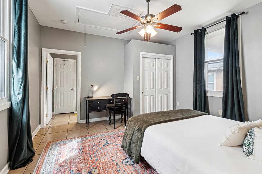 The primary bedroom has been thoughtfully designed with black out curtains, and a desk which can double as a makeup vanity!