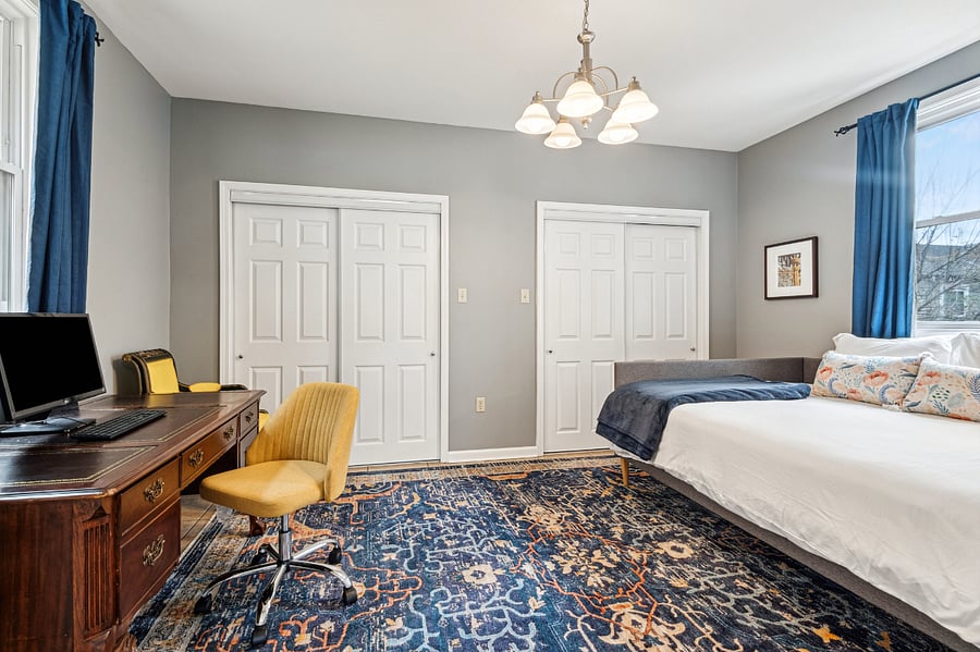 The office, which doubles as a guest room and features two large closets and a computer monitor and keyboard.