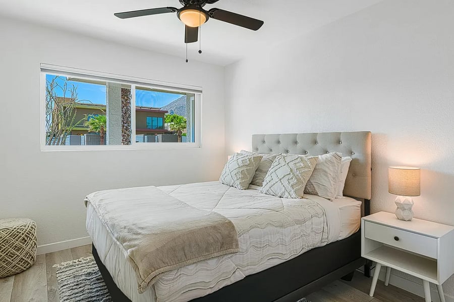 The third bedroom offers a queen bed, smart TV, blackout shade, and ceiling fan for a restful stay.