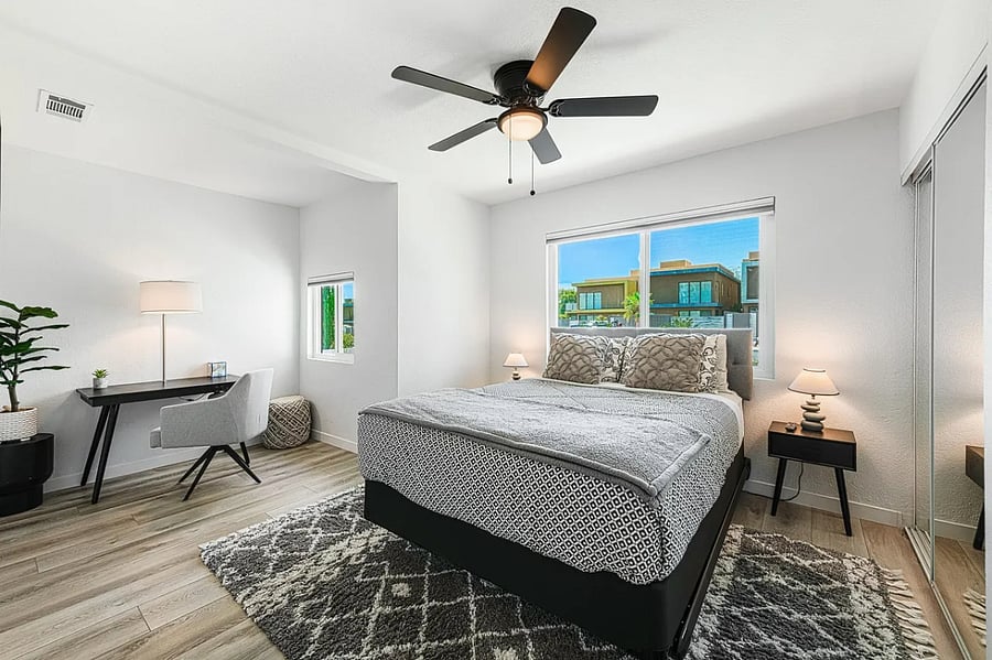This versatile bedroom includes a queen bed and a tucked-away home office alcove for focused work.