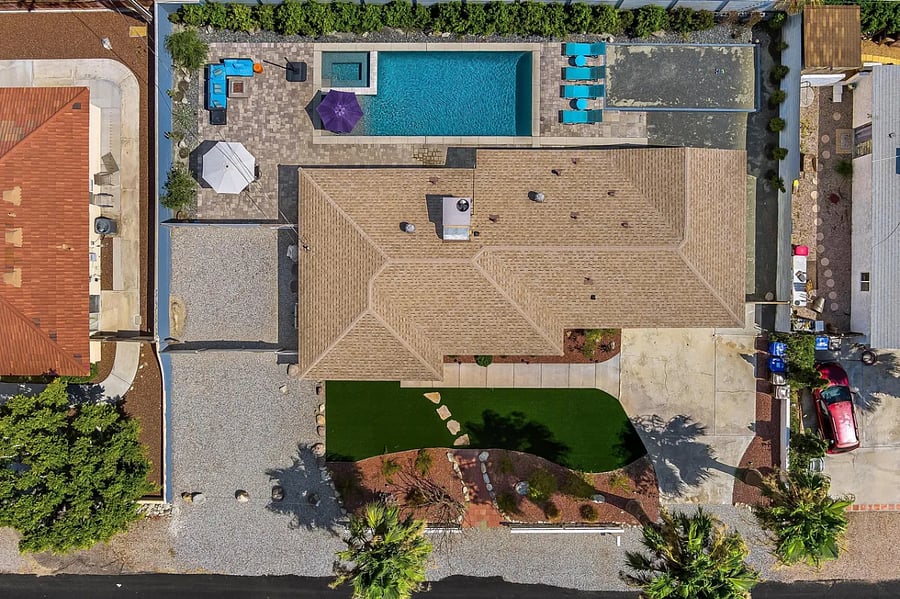 - A stunning aerial view showcases the full layout of this private retreat, from the saltwater pool and spa to the fully fenced backyard and charming one-story home.