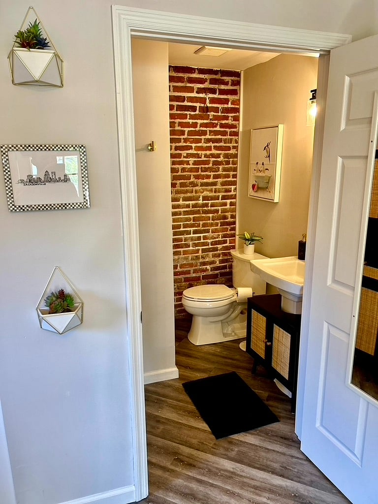 Bath room with walk-in shower and under sink storage, plus additional storage in bathroom closet.