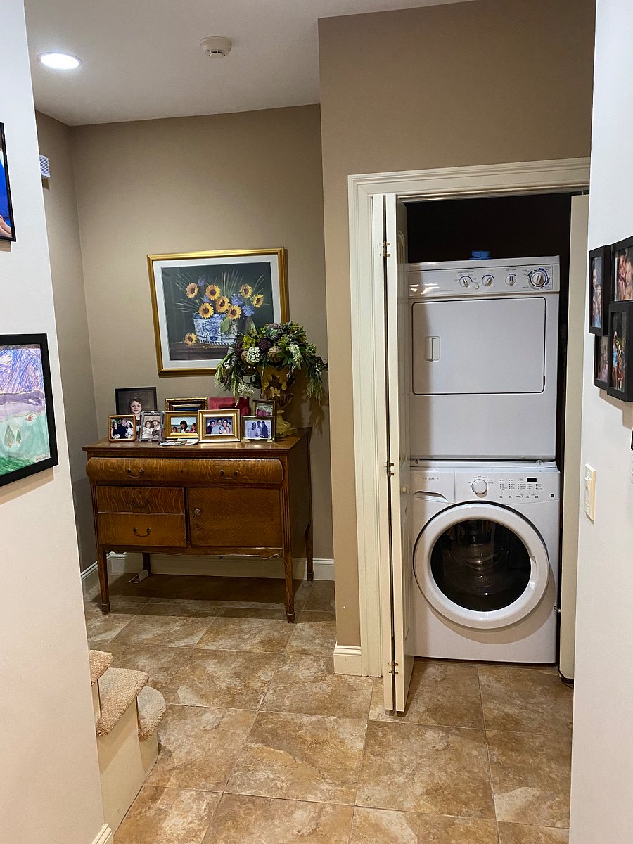 Stacked washer/dryer hidden behind Louvre door closet.