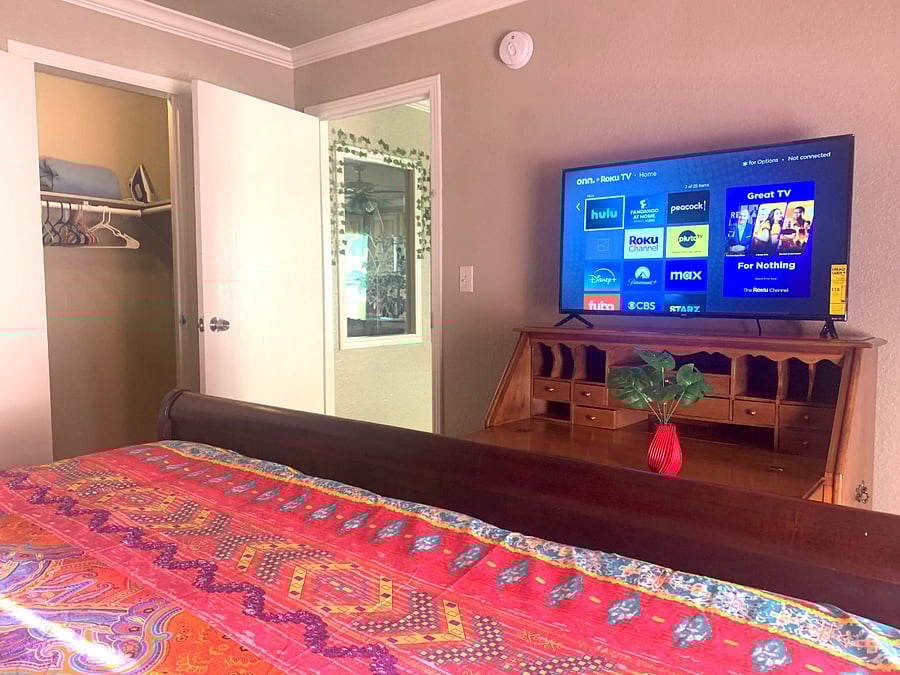 A full-size bathroom, walk-in closet and 40" Smart Roku TV.