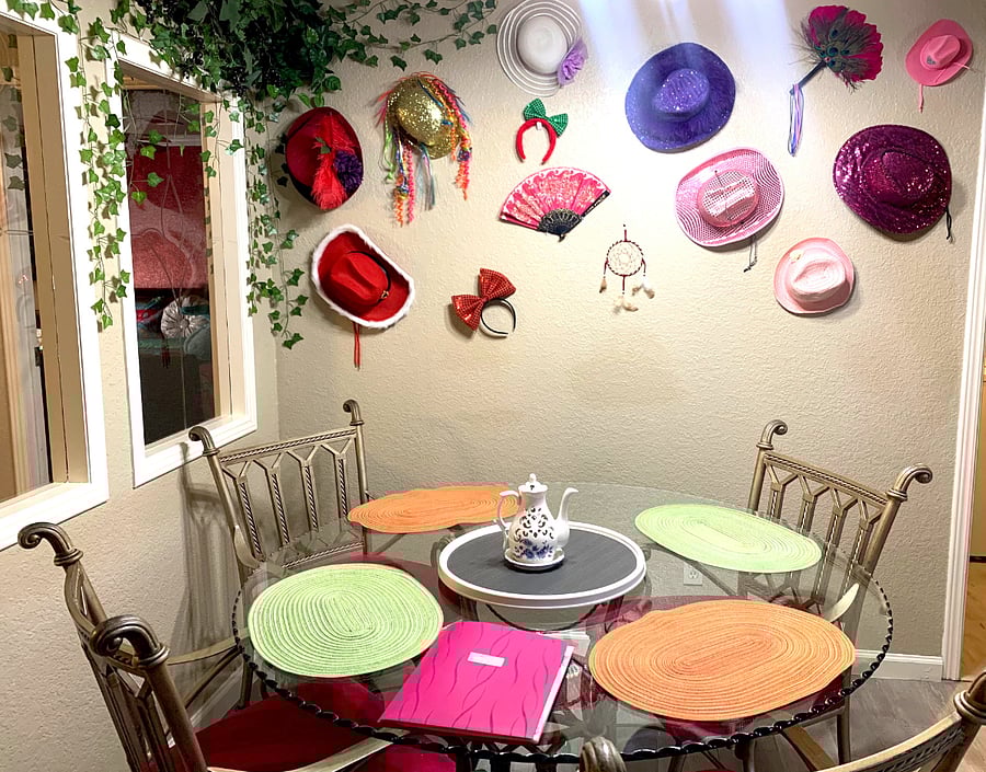 Unique interior with a collection of various hats and fans.