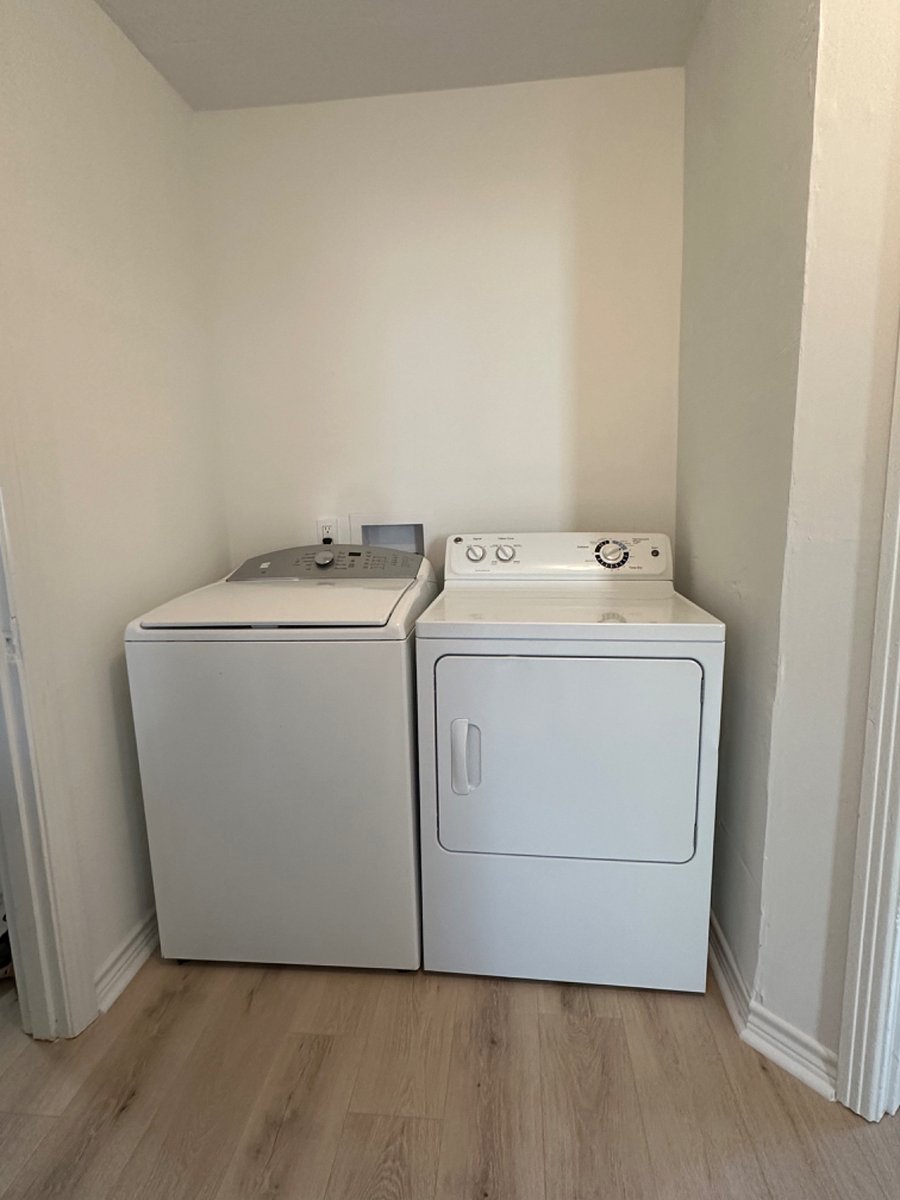washer and dryer in the hallway across the bathroom 