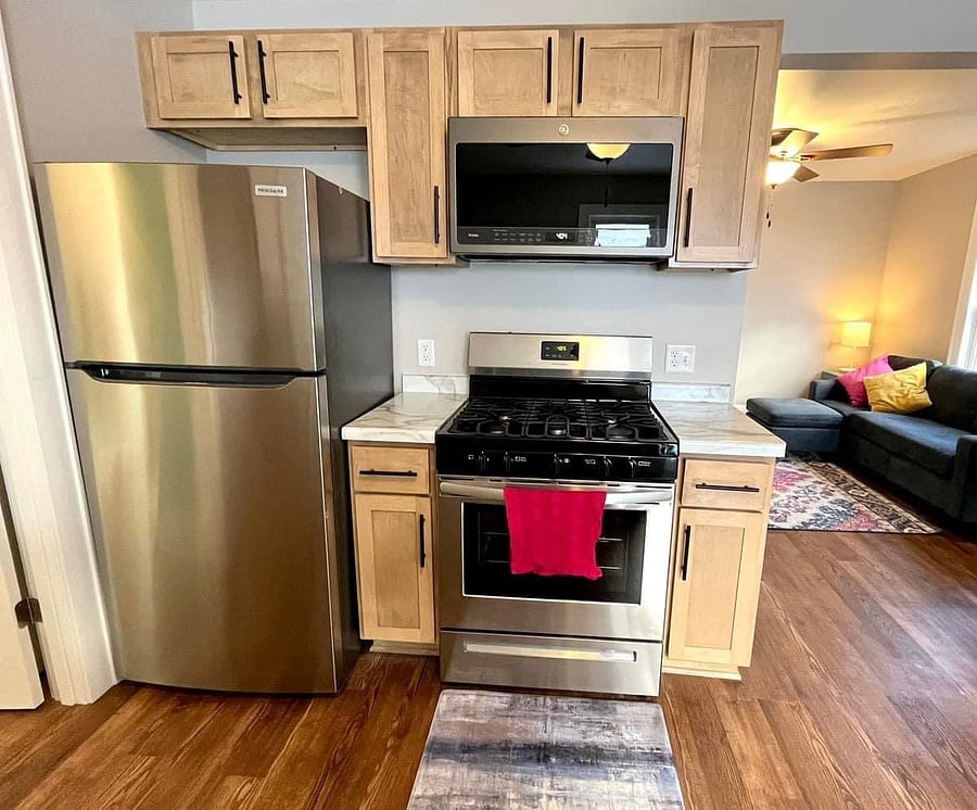 Kitchen with full sized refrigerator and stove/oven.