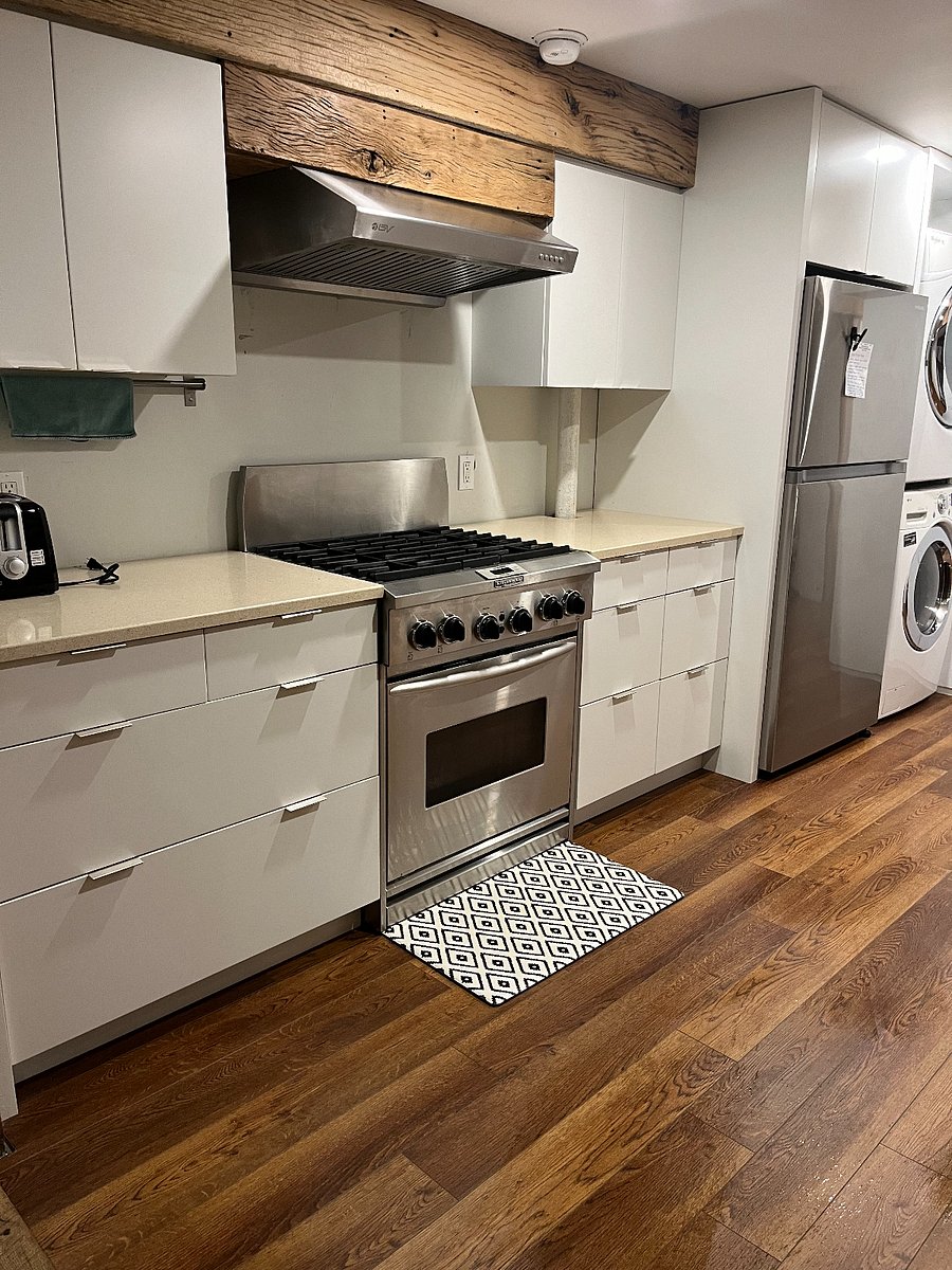 kitchen with full sized refrigerator, stove and washer/dryer