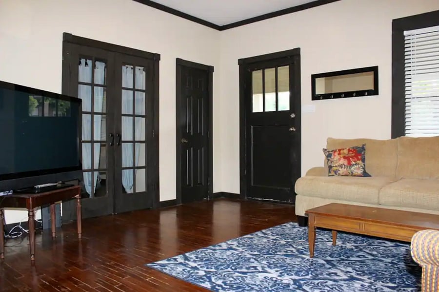 Smart TV and view of french doors to third bedroom
