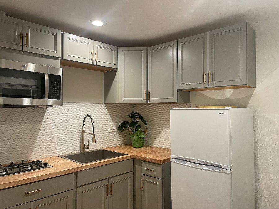 Kitchen features include fridge, stove, garbage disposal, microwave, stainless steel sink, butcher block countertops