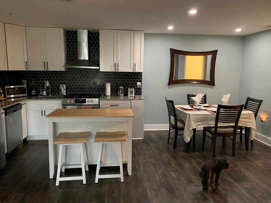 A fully equipped kitchen featuring a coffee maker, microwave, dishwasher, oven and all essential utensils.