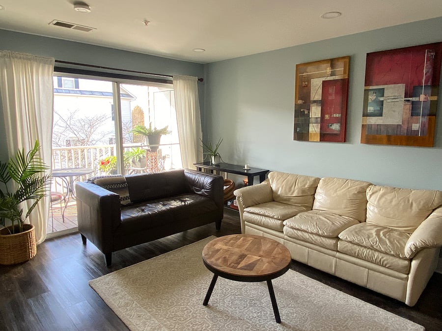 A bright and inviting living area, enhanced by large windows that welcome abundant natural light.