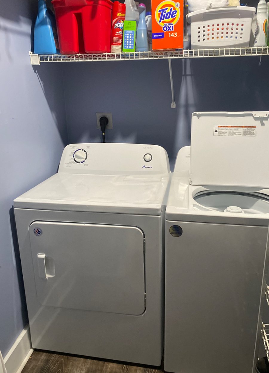 Washer and dryer as well as storage space for shoes.