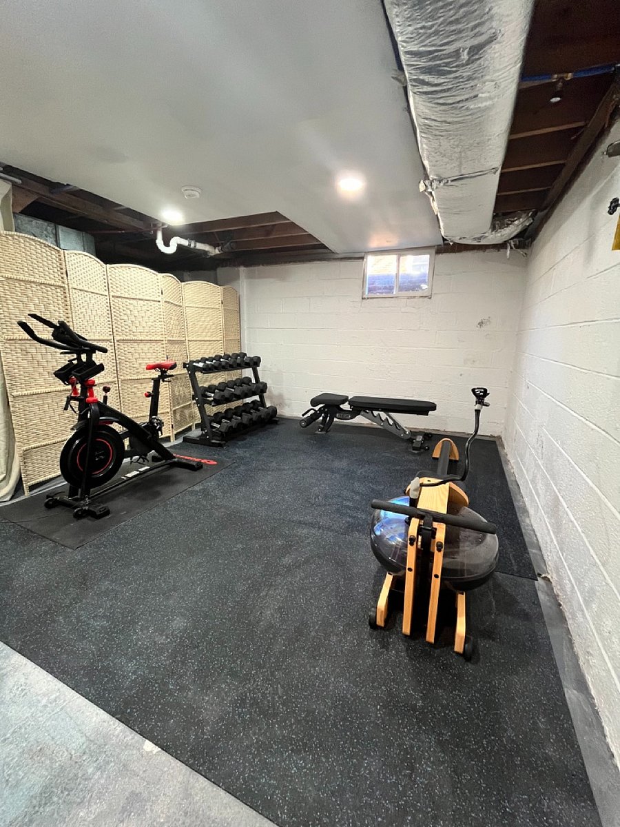 Home gym with exercise bike, full weight set, bench, rower and a large TV!