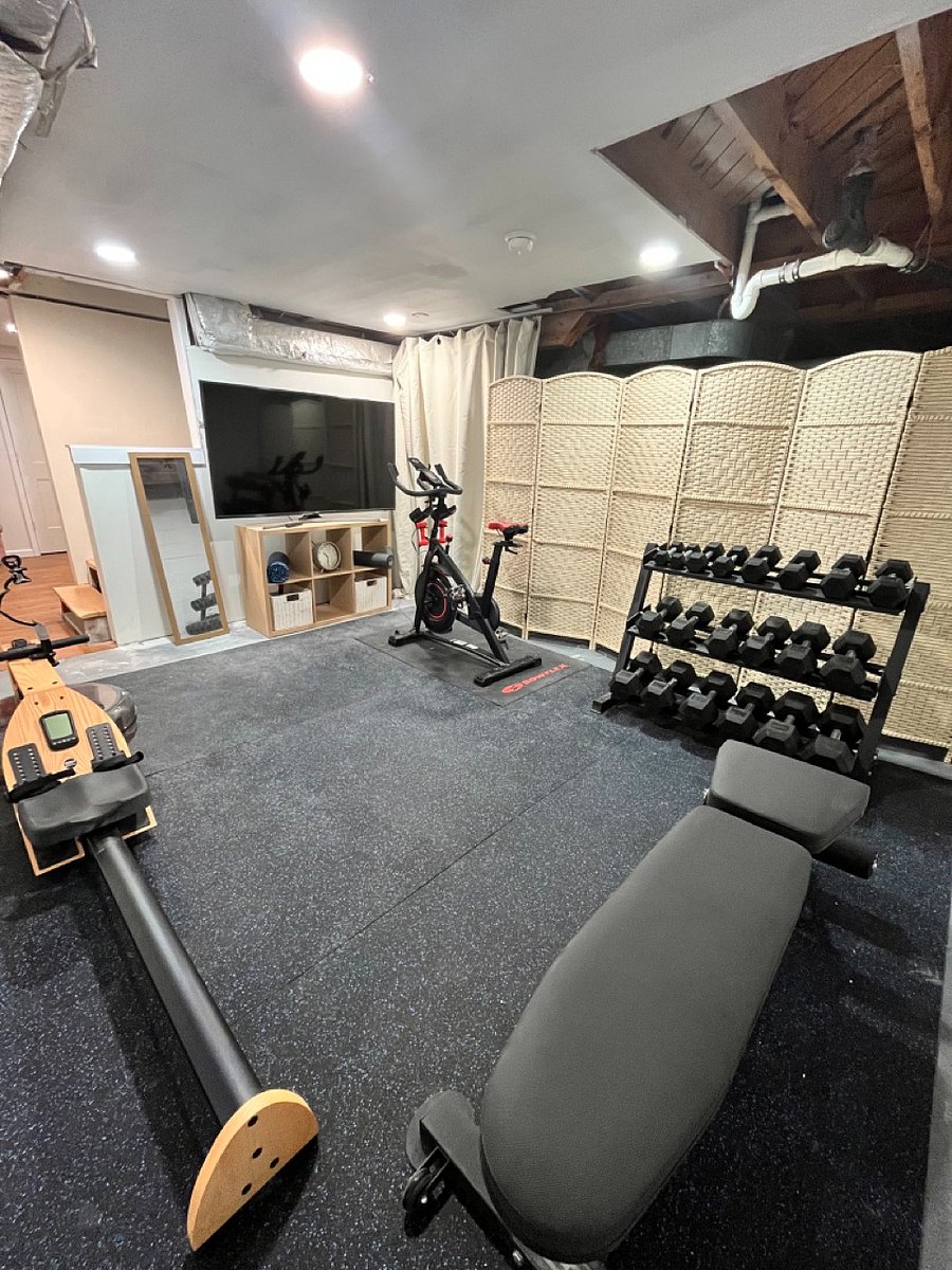 Home gym with exercise bike, full weight set, bench, rower and a large TV!