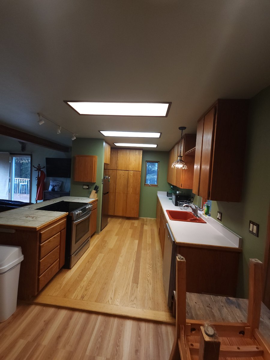 Kitchen with custom made cabinetry, stove/ oven, dishwasher, microwave, and refrigerator