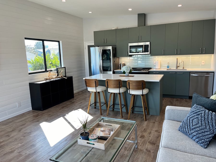 Kitchen island with seating for 3.
Island has electrical outlets for charging devices.
4-burner range with center griddle.
Reverse-osmosis water dispenser.
French-door refrigerator with beverage window.
Dishwasher.
Built-in microwave.