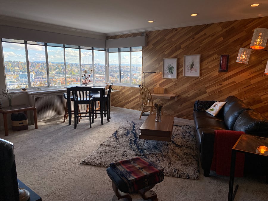 Wide angle shot into living room, quiet and restfull, foldaway computer table, easy recliner for watching the Youtube fireplace.