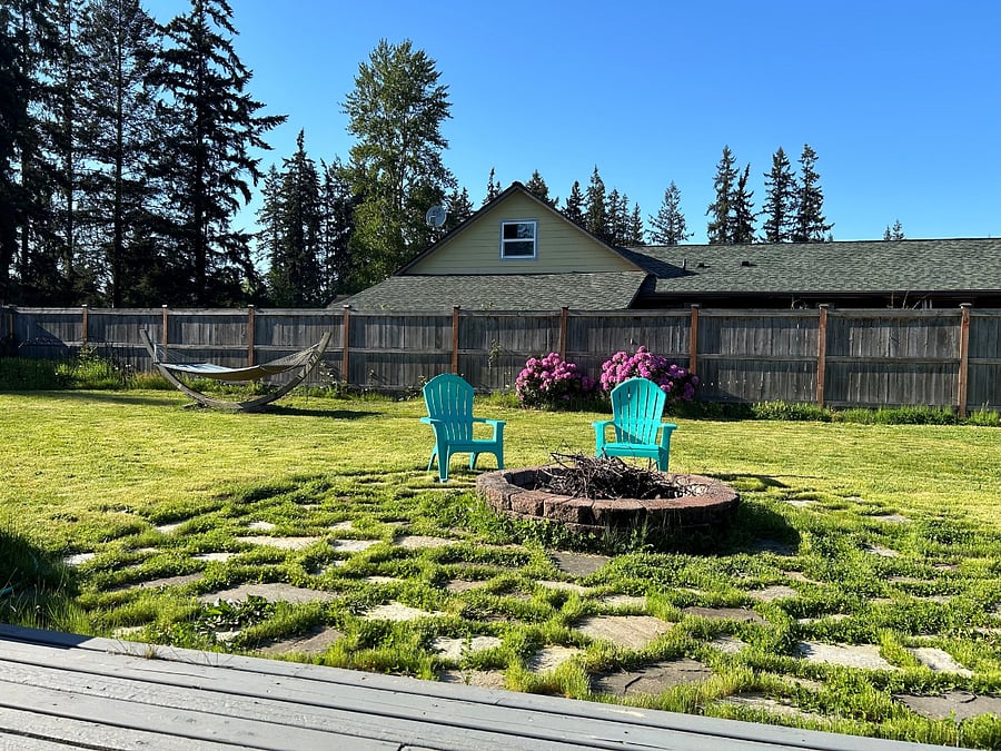 large shared back yard with fire pit