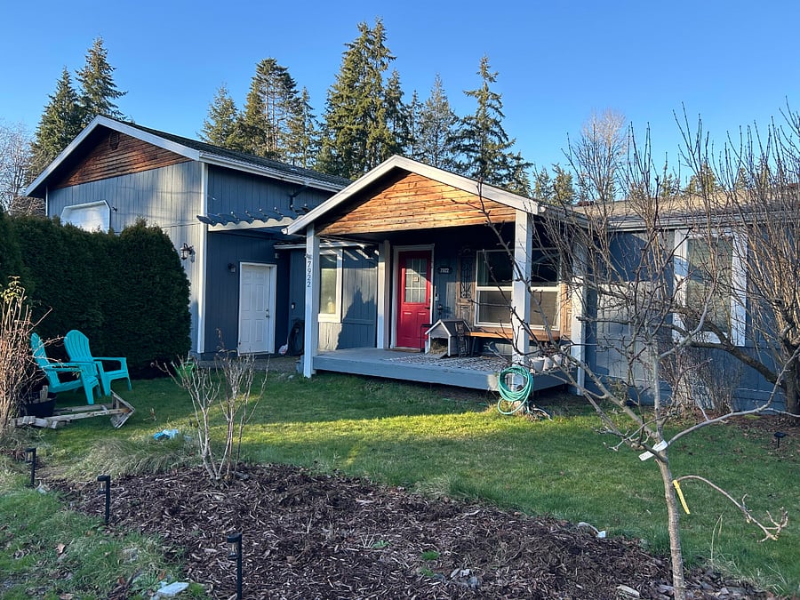 Winter time view of house...trees with no leaves and empty flowerbed