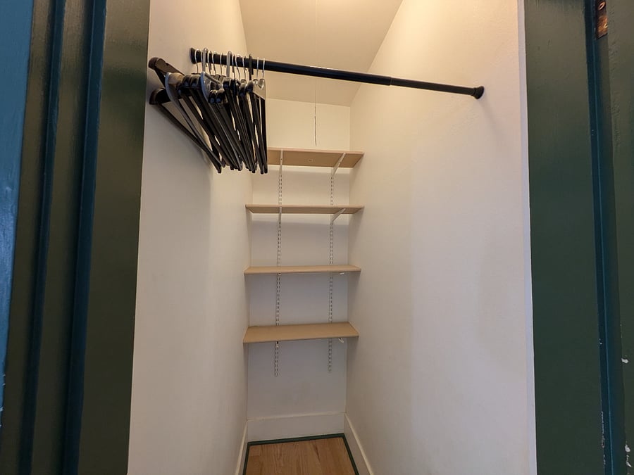 Deep closet with hanging and folding space.