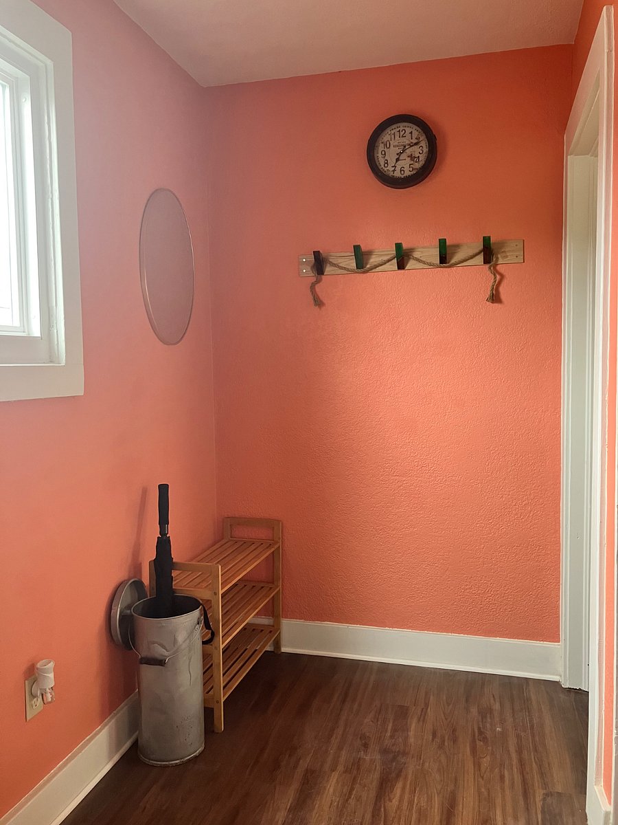 Coat rack, umbrella stand, and shoe rack on landing.